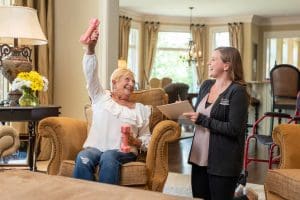 Caregiver-Caregiver-Supporting Senior with Exercises Regiment at Home