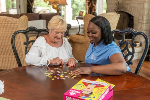 Senior Caregiver with Elder and Puzzle Activity